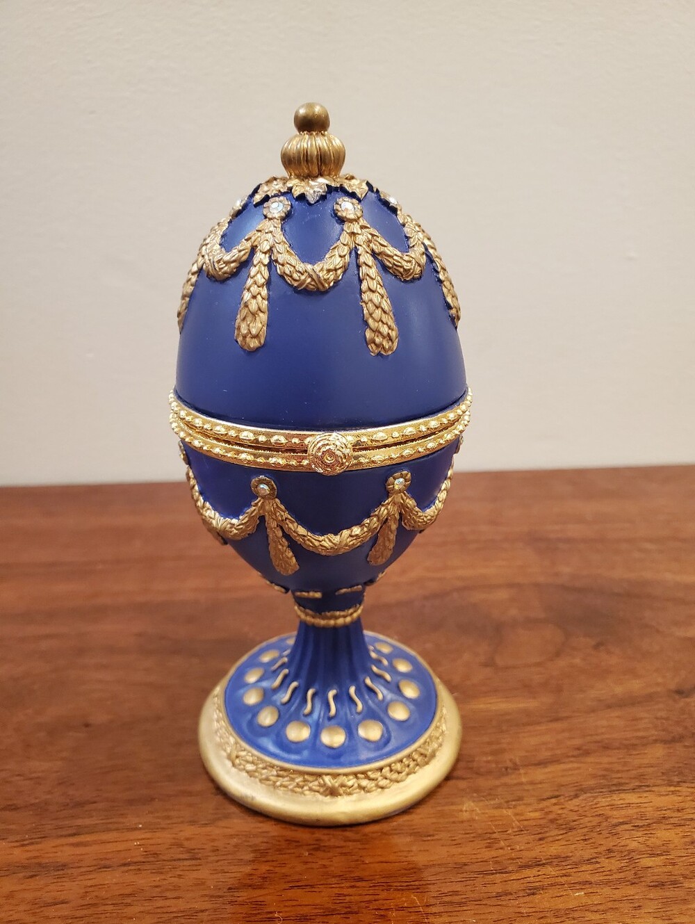 Royal blue and gold-trimmed musical egg trinket box.